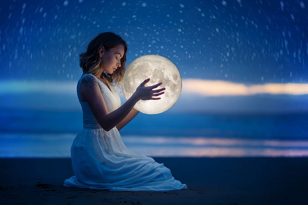Woman holding the moon on a night beach. Goddess Artemis Lunar Wisdom - Carla Lima Online Course