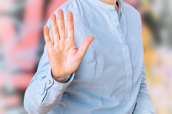 Woman signals defensive attitude with hand. Goddess Artemis Self-Defense - Carla Lima Online Course