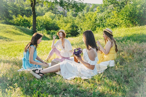 Women girlfriends having fun together at a picnic in the forest. Goddess Artemis Sisterhood - Carla Lima Online Course